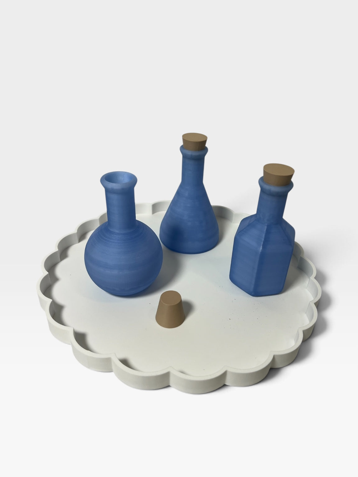 Blue potion bottles with corks on a white Christmas activity tray
