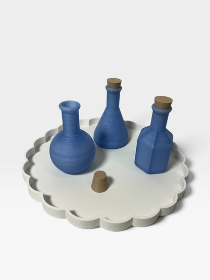 Blue potion bottles with corks on a white Christmas activity tray